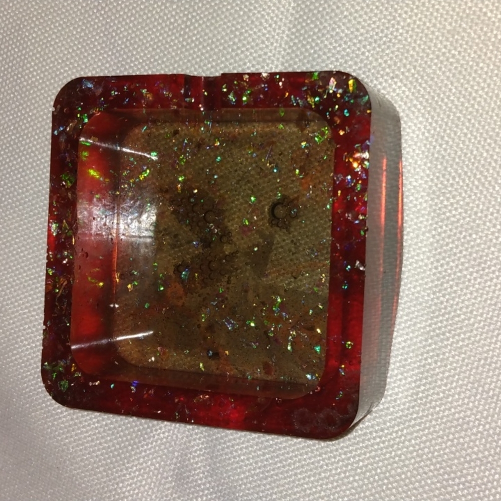 Red ashtray with flakes